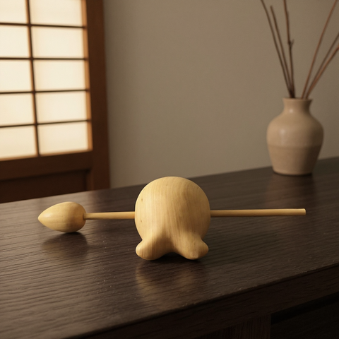 Wooden Fish on a wooden surface with a softly lit background